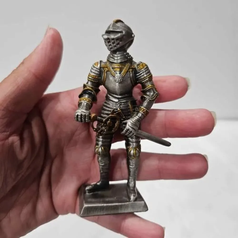 Small metal knight figurine with armor and sword